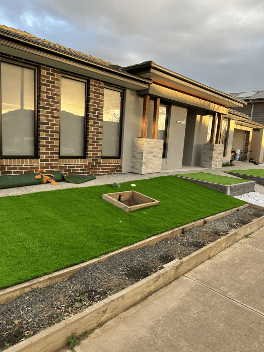 Neatly finished lawn with premium synthetic turf laid by Gardenscape.